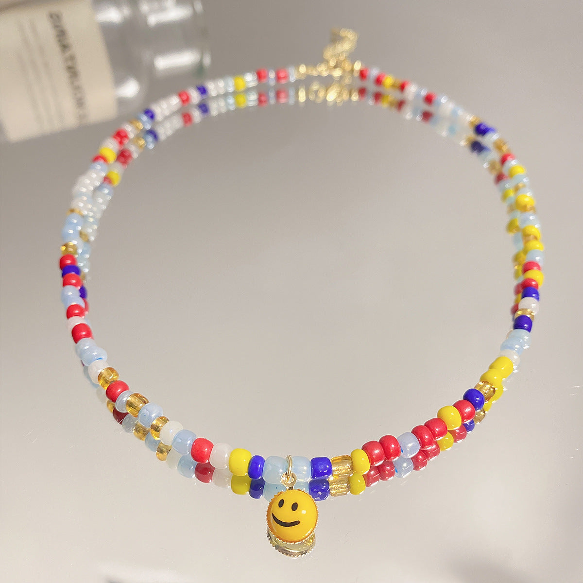 Venta al por mayor Collar de cara de sonrisa de perlas de color de vidrio